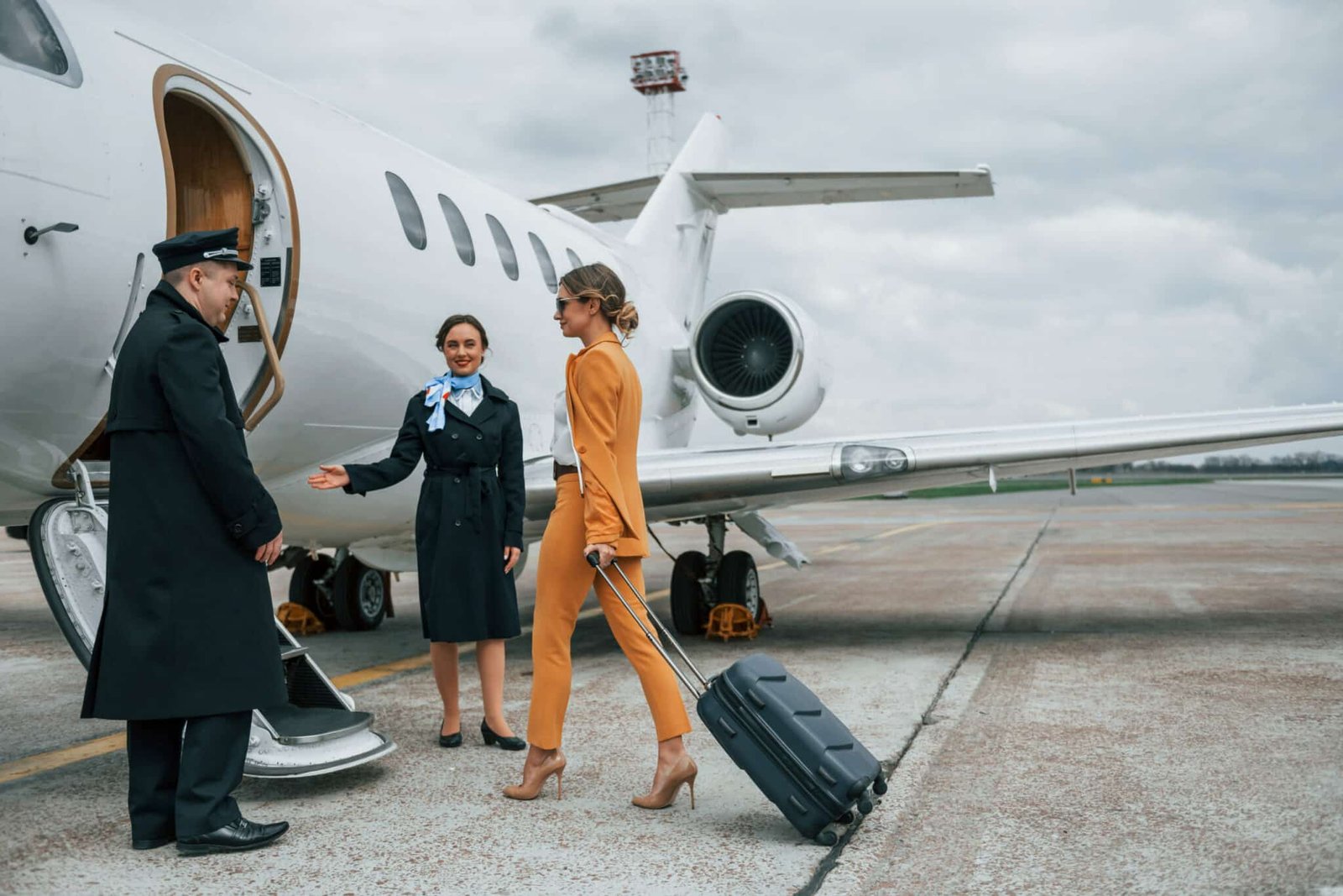 Woman boarding a private jet with the assistance of Pearl Lemon Jet crew.