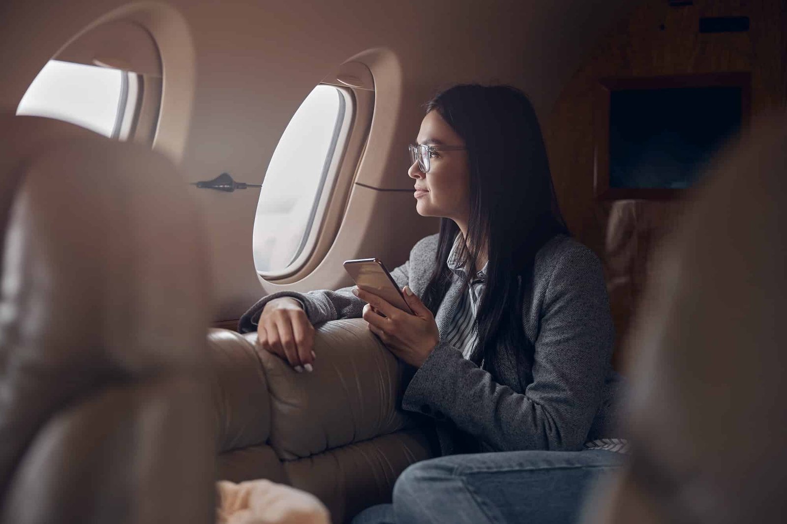 Happy smiling beautiful business woman in private jet