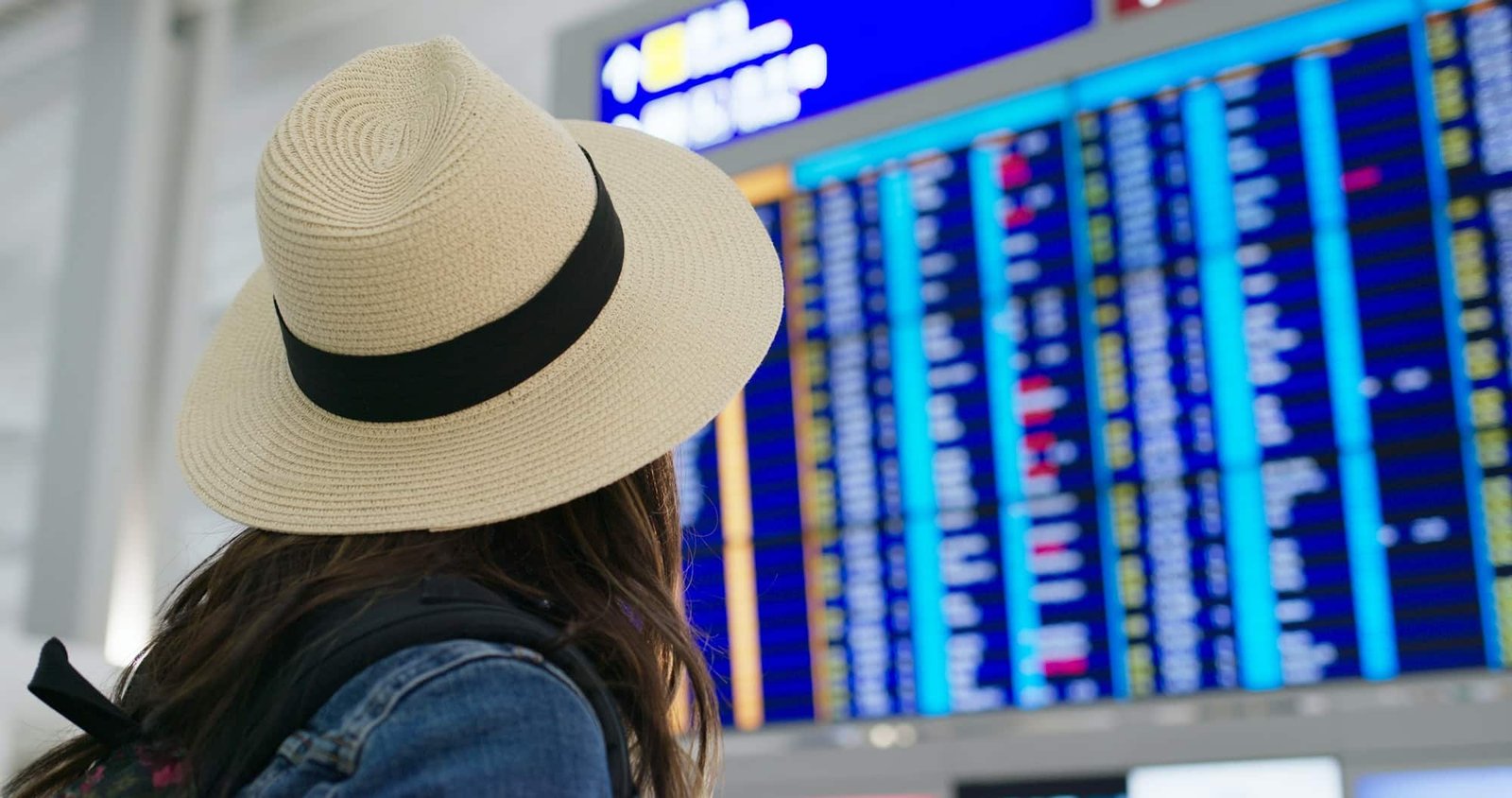 Girl looking at the flight schedule for private jets at London airport