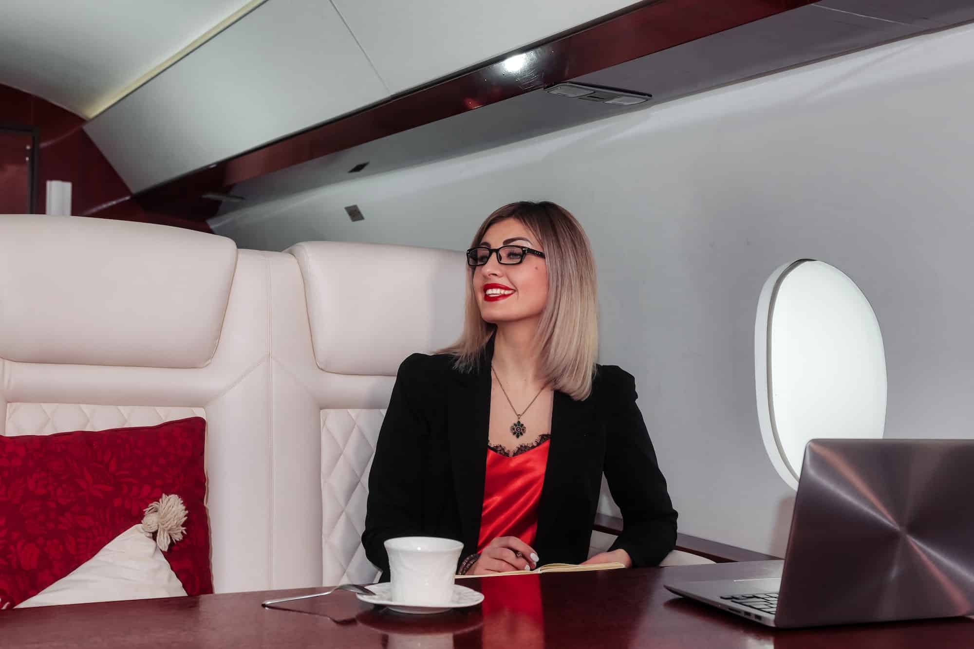Young business woman in room of private plane. Concept of successful life and luxury travel