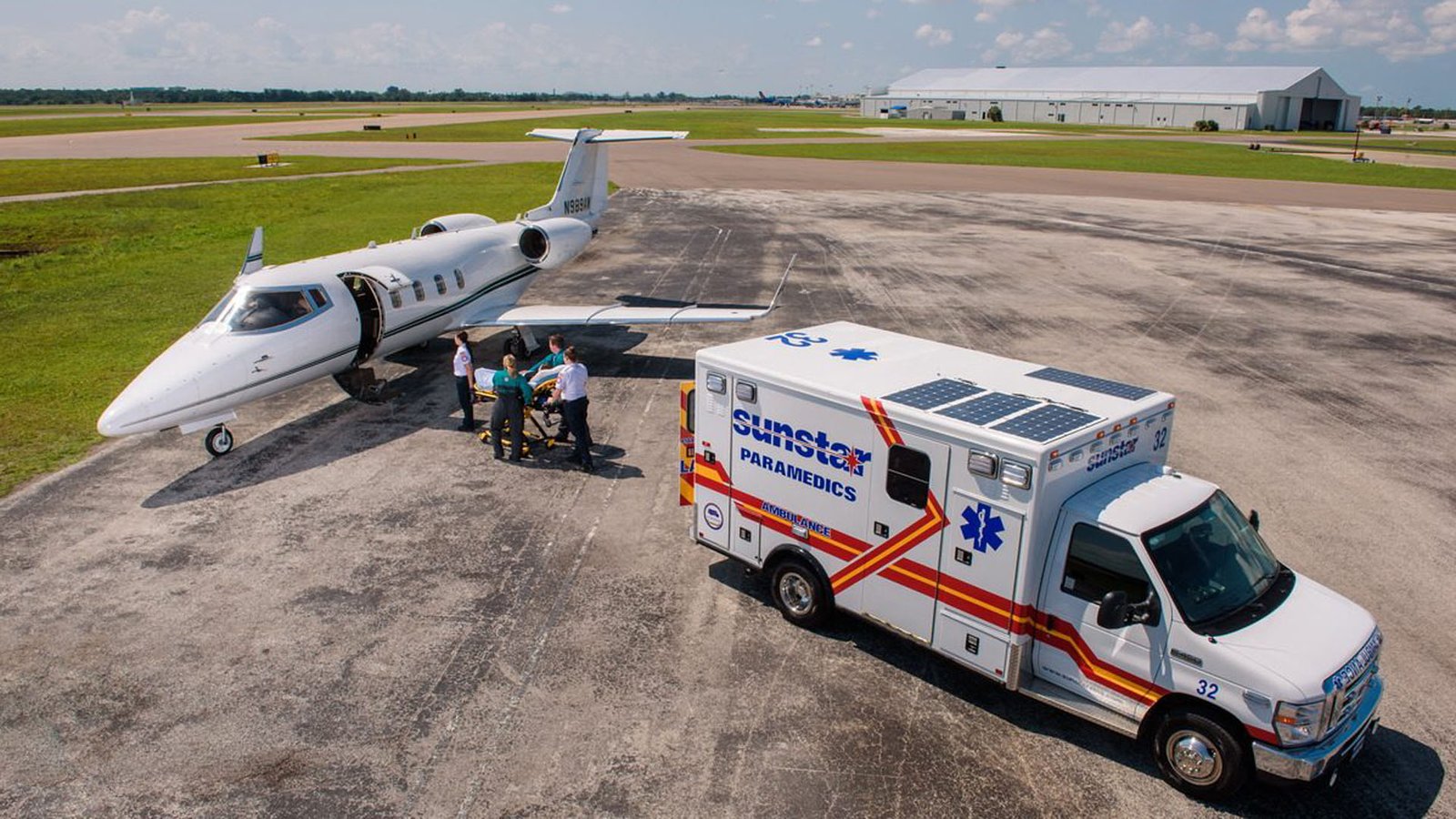 Medical staff transferring a patient from a regular ambulance into an air ambulance