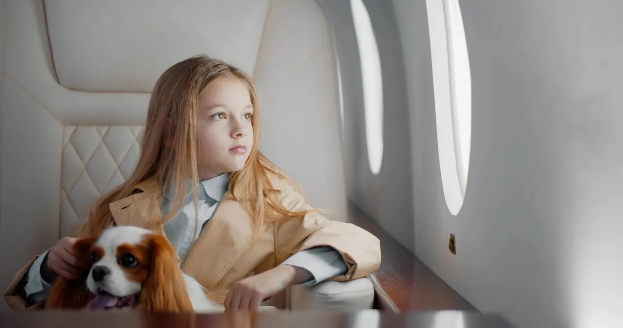 A girl enjoying a charter flight with her pet.