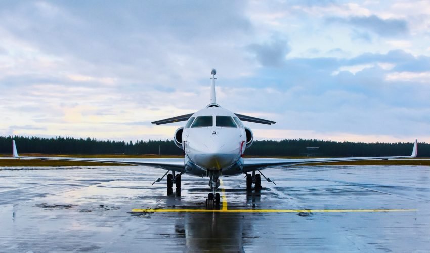 Private-jet-on-airport-runway-under-cloudy-sky-facing-camera