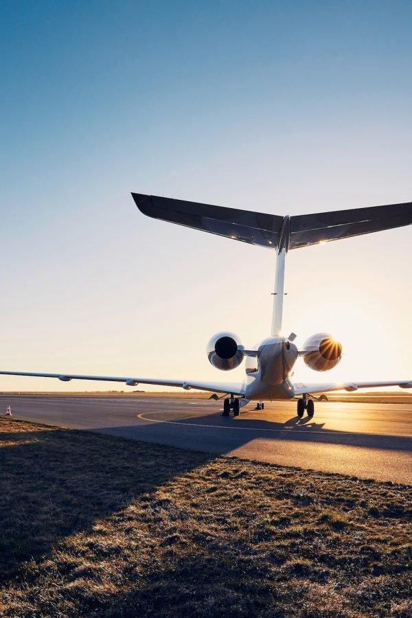 Airport at sunset. Silhouette of private jet against runway. Airport at sunset. Silhouette of private jet against runway.