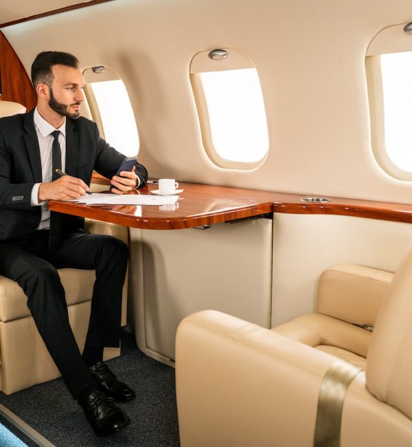 Businessman flying on private jet